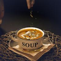 una taza de sopa sentada en una mesa en Hotel Pagony Wellness, en Nyíregyháza