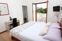 Postel nebo postele na pokoji v ubytování Rooms and Apartment Luana