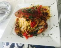 a plate of food with a sandwich with pasta at Villa Neptunus in Ischia