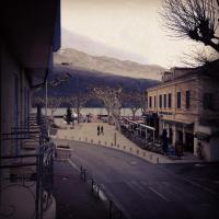 a street in a town with a mountain in the background at Hôtel L&#39;Iroko The Originals City in Aix-les-Bains