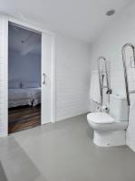 a white bathroom with a toilet and a bed at Delamar 4*Sup-Adults only (18+) in Lloret de Mar
