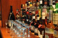 a group of wine bottles and glasses on a bar at Reenskaug Hotel in Drøbak