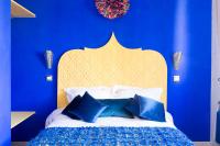 a blue bedroom with a bed with a blue wall at Riad SPA &quot;Les Portes de l&#39;Orient&quot; TOURS in Tours