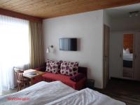 a hotel room with a bed and a couch at Gasthof Panorama in Obsteig