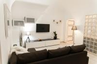 Televízia a/alebo spoločenská miestnosť v ubytovaní Ricciarelli Home
