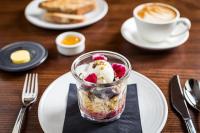 a dessert in a glass on a plate with a cup of coffee at Fable Auckland, MGallery in Auckland