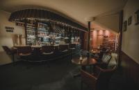 a bar in a restaurant with chairs and tables at Hotel Restaurant Boss in Miłosław