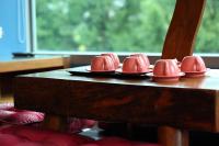a group of pink dishes on a wooden table at Pretty Sun B&amp;B in Ji&#39;an