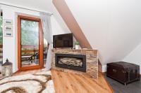 Televízia a/alebo spoločenská miestnosť v ubytovaní Apartamenty Sun & Snow Kościelisko Residence