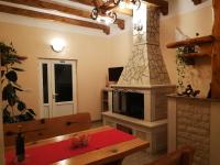 a living room with a table and a fireplace at Apartman Fachin in Motovun