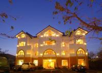 a large white building with cars parked in front of it at Sea of Clouds Vacation Villa in Ren&#39;ai