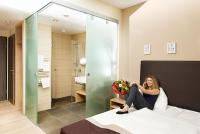 A bed or beds in a room at Hotel Krainerhütte