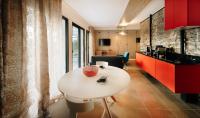 a kitchen with a white table in a room at Citta di Lume Suites &amp; Lofts in Porto-Vecchio