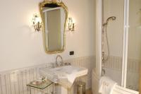 a white bathroom with a sink and a mirror at Hotel Locanda Dei Mai Intees in Azzate