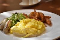 a white plate of food with eggs and potatoes at Hotel Intrendy in Taishan