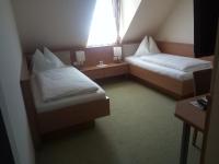 A bed or beds in a room at Hotel Restaurant zum Schwan