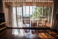 a living room with a table and chairs and windows at Summer Ya B&amp;B in Huxi