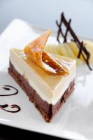 a piece of cake on a white plate at Logis Hotel des Bourbons Montluçon Climatisé in Montluçon