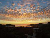 a sunset view of the ocean and the sky at Casa Arcoiris Zihuatanejo B&B in Zihuatanejo