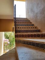 a staircase in a house with tiles on the stairs at Casa Arcoiris Zihuatanejo B&B in Zihuatanejo