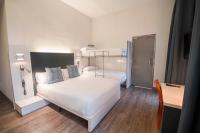 A bed or beds in a room at Petit Palace Canalejas Sevilla