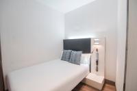 A bed or beds in a room at Petit Palace Canalejas Sevilla