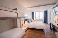 A bed or beds in a room at Petit Palace Canalejas Sevilla