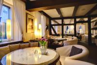 Una sala de estar con sofás y una mesa y sillas. en Hotel-Restaurant Schillingshof, en Friedland