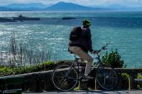 a person on a bike looking at the water at Hotel Villa Catarie in Guéthary