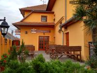 a building with benches in front of a building at Penzion Bouquet in Horní Věstonice