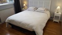 a bedroom with a large white bed with two pillows at Moulin de Chappes in Chappes