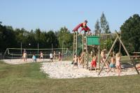a group of children playing on a playground at Le Domaine des Fargues in Sainte-Foy-de-Longas