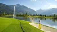 two men are standing on the shore of a lake at Hotel Garni Landhaus Gitti in Zell am See