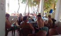 a group of young men sitting at a table at Jayanthi Surf Dreams in Midigama