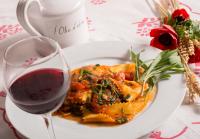 a white plate of food with a glass of wine at Hotel Felix in Rimini