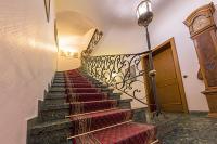 a stairway with red carpeted stairs in a building at Burghotel in Rothenburg ob der Tauber