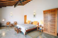 a bedroom with a bed and a table and chairs at Highland Villa in Weligama