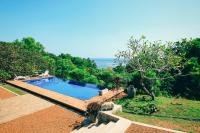 a swimming pool with a view of the ocean at Highland Villa in Weligama