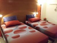 two beds sitting next to each other in a room at Baan Baimai Boutique Room in Phra Nakhon Si Ayutthaya
