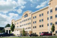 a hotel with cars parked in front of it at Baymont by Wyndham Erie in Erie