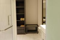 a bathroom with a sink and a cabinet with towels at Maehaad Bay Resort - SHA Plus in Mae Haad