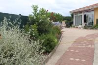 a garden with a hose attached to a house at La Nouste Maisoun in Barcelonne-du-Gers