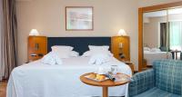 A bed or beds in a room at URH Ciutat de Mataró