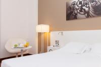 A bed or beds in a room at URH Ciutat de Mataró