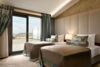 A bed or beds in a room at Ramada by Wyndham Yalova