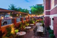 Un patio al aire libre con mesas, sillas y luces. en The George Washington - A Wyndham Grand Hotel, en Winchester