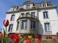 a white house with flowers in front of it at Villa Élyane in Colmar