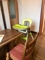 a green high chair sitting next to a table at Pension Karina Schwerin in Schwerin