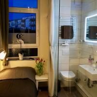 a bathroom with a bed and a toilet and a sink at Pension Karina Schwerin in Schwerin