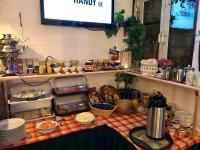 a kitchen counter with food on a table at Pension Karina Schwerin in Schwerin